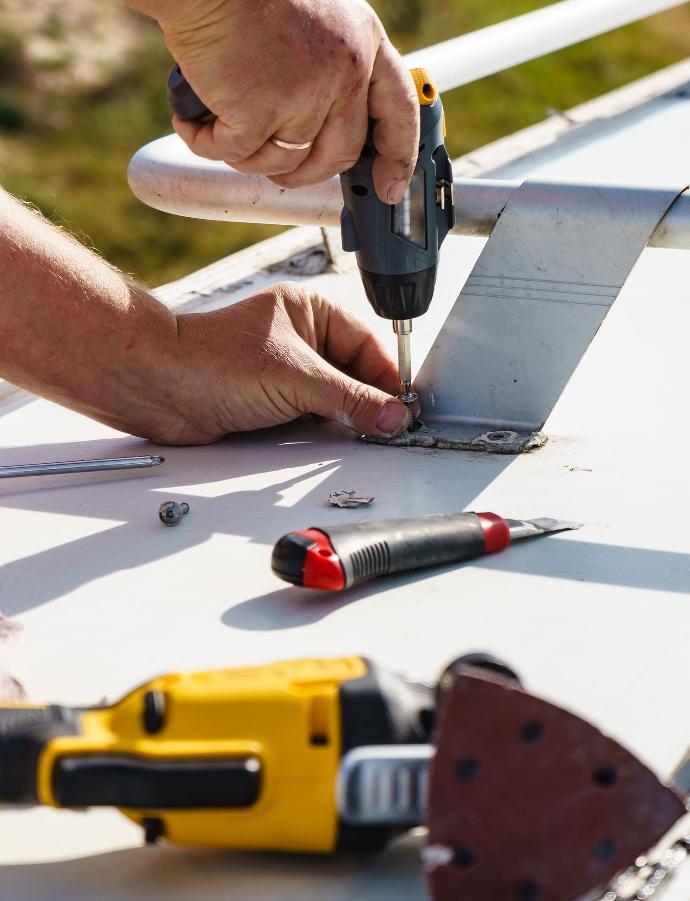 Technician performing an RV roof repair
