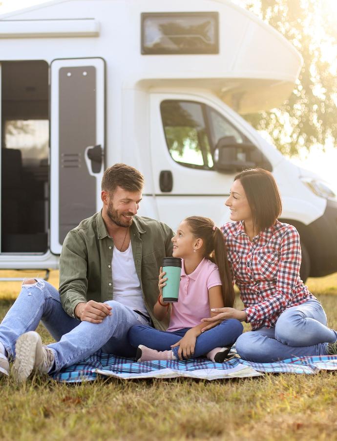 A family relaxing outside their RV in the Texas Hill Country